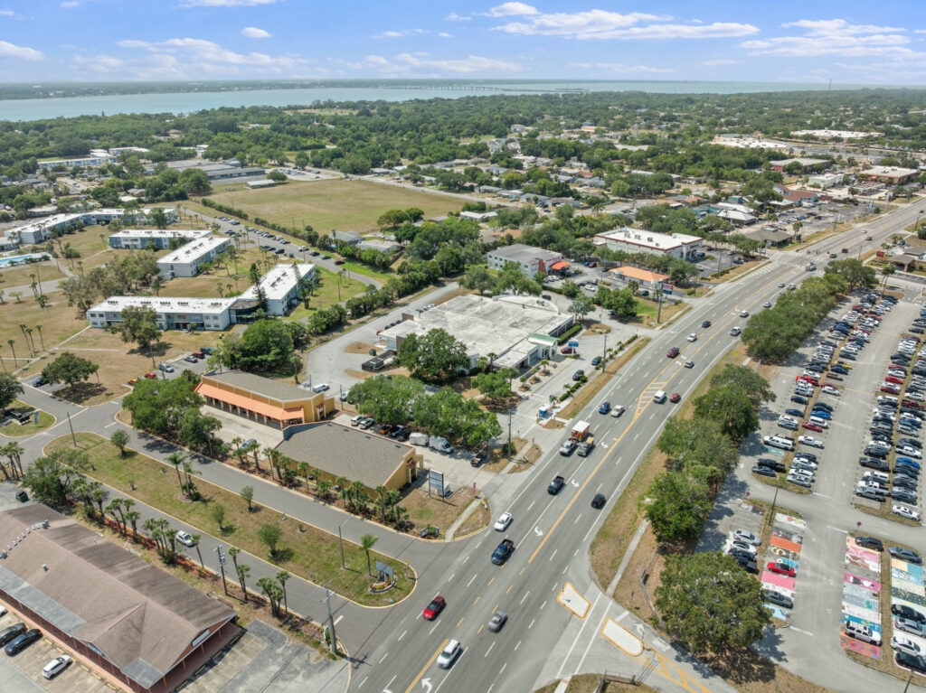An aerial view of the Perrone Village buildings at 1175 North Courtenay Parkway in Merritt Island, Florida.