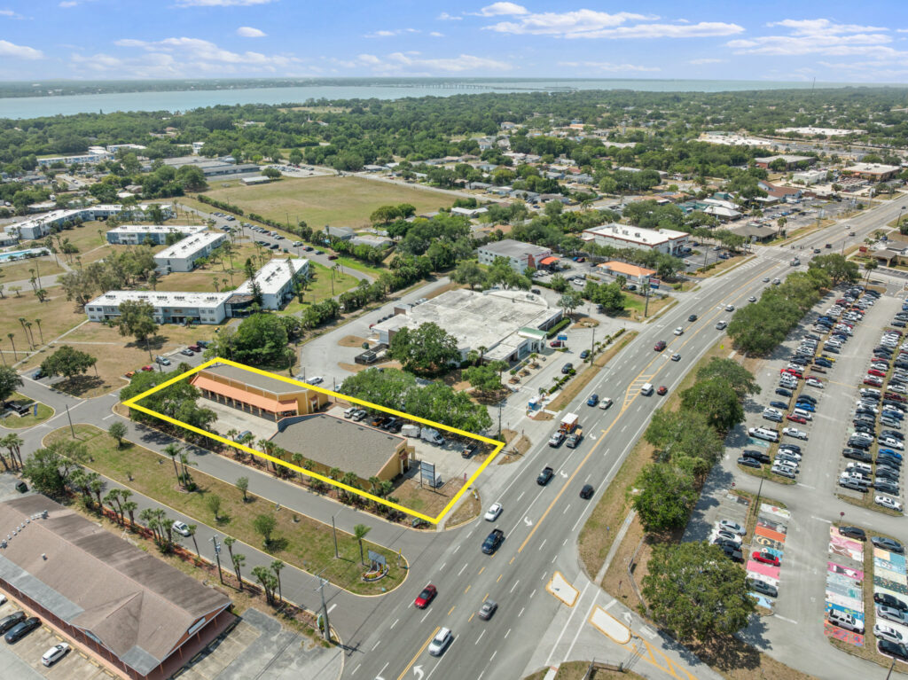 An aerial view of the Perrone Village buildings at 1175 North Courtenay Parkway in Merritt Island, Florida.