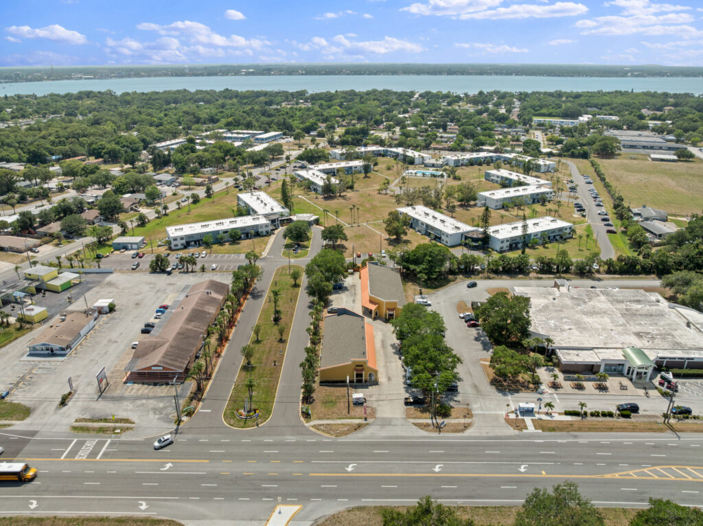 An aerial view of the Perrone Village buildings at 1175 North Courtenay Parkway in Merritt Island, Florida.