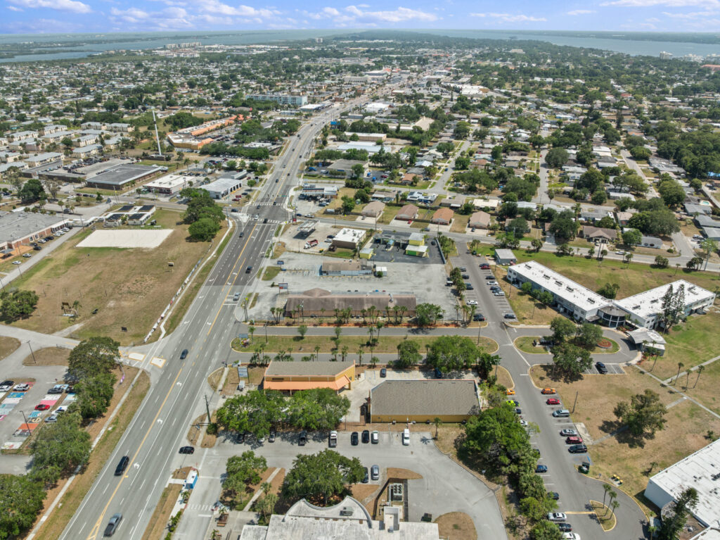 An aerial view of the Perrone Village buildings at 1175 North Courtenay Parkway in Merritt Island, Florida.