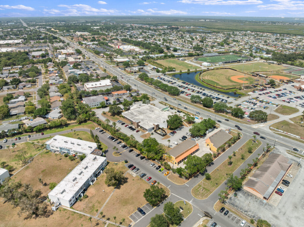 An aerial view of the Perrone Village buildings at 1175 North Courtenay Parkway in Merritt Island, Florida.