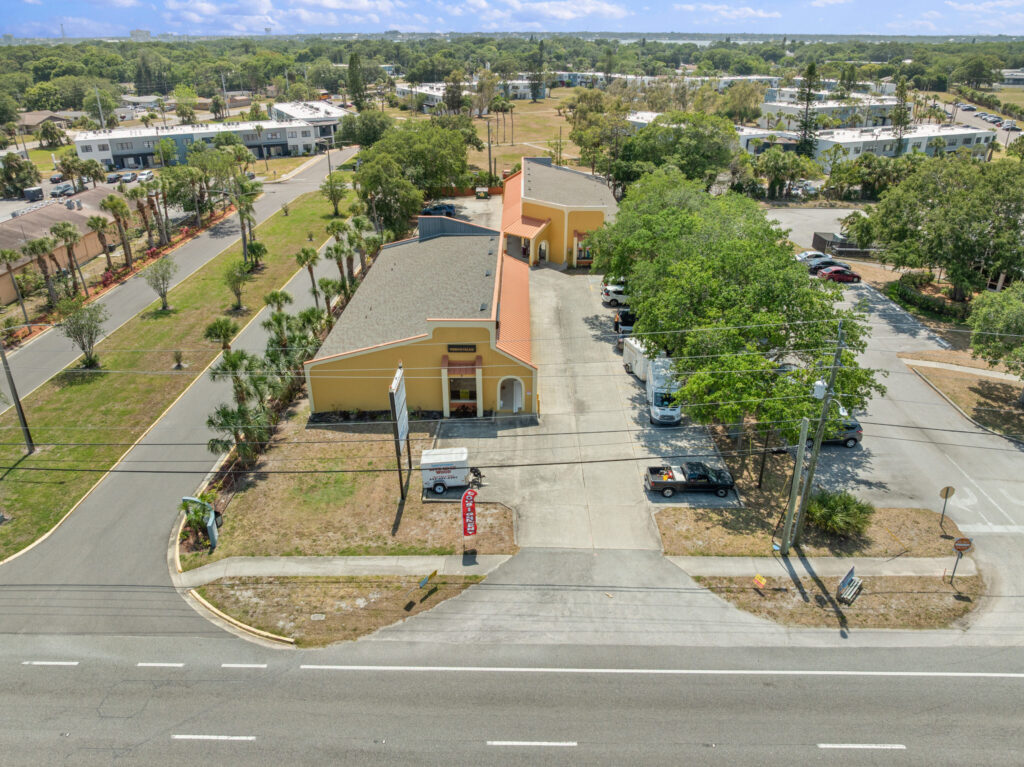 An aerial view of the Perrone Village buildings at 1175 North Courtenay Parkway in Merritt Island, Florida.