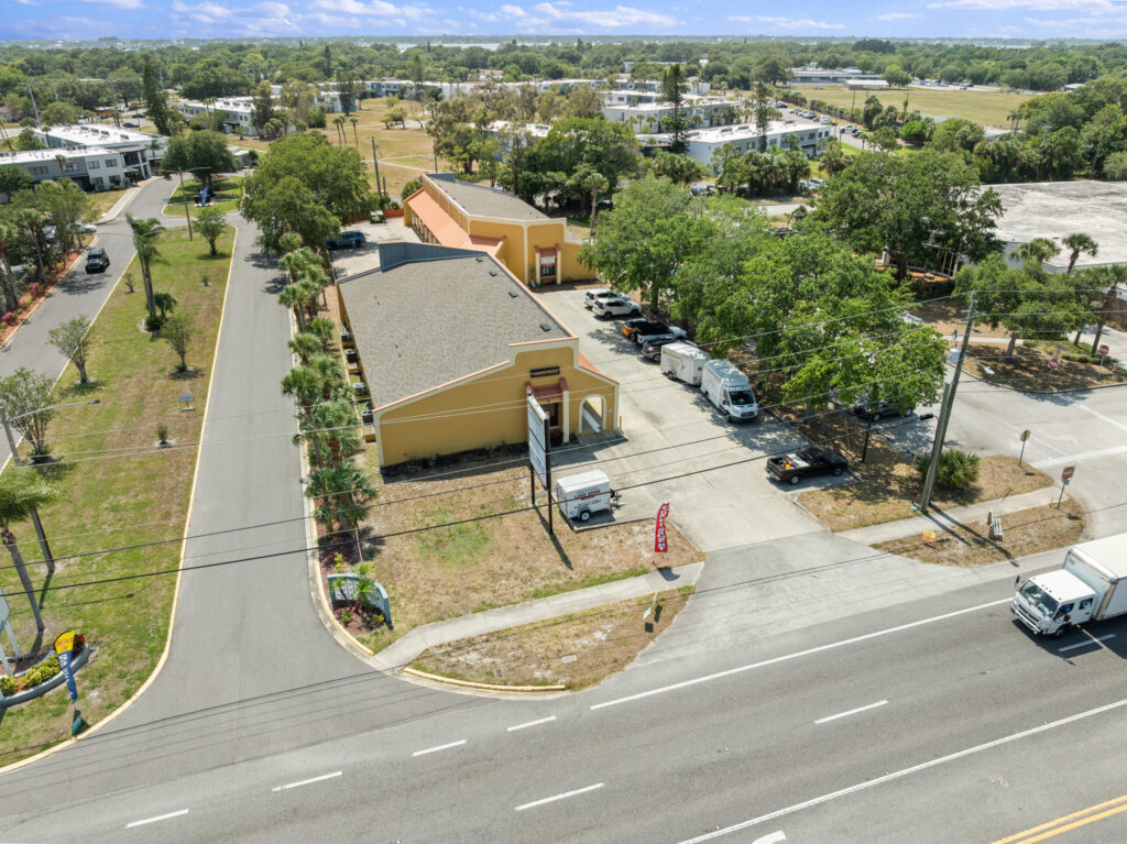 An aerial view of the Perrone Village buildings at 1175 North Courtenay Parkway in Merritt Island, Florida.