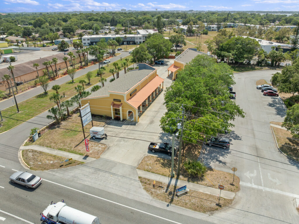 An aerial view of the Perrone Village buildings at 1175 North Courtenay Parkway in Merritt Island, Florida.