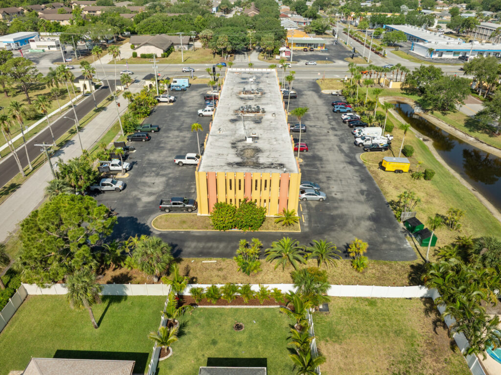 An aerial view of the Perrone Plaza building located at 2460 North Courtney Parkway in Merritt Island, Florida.